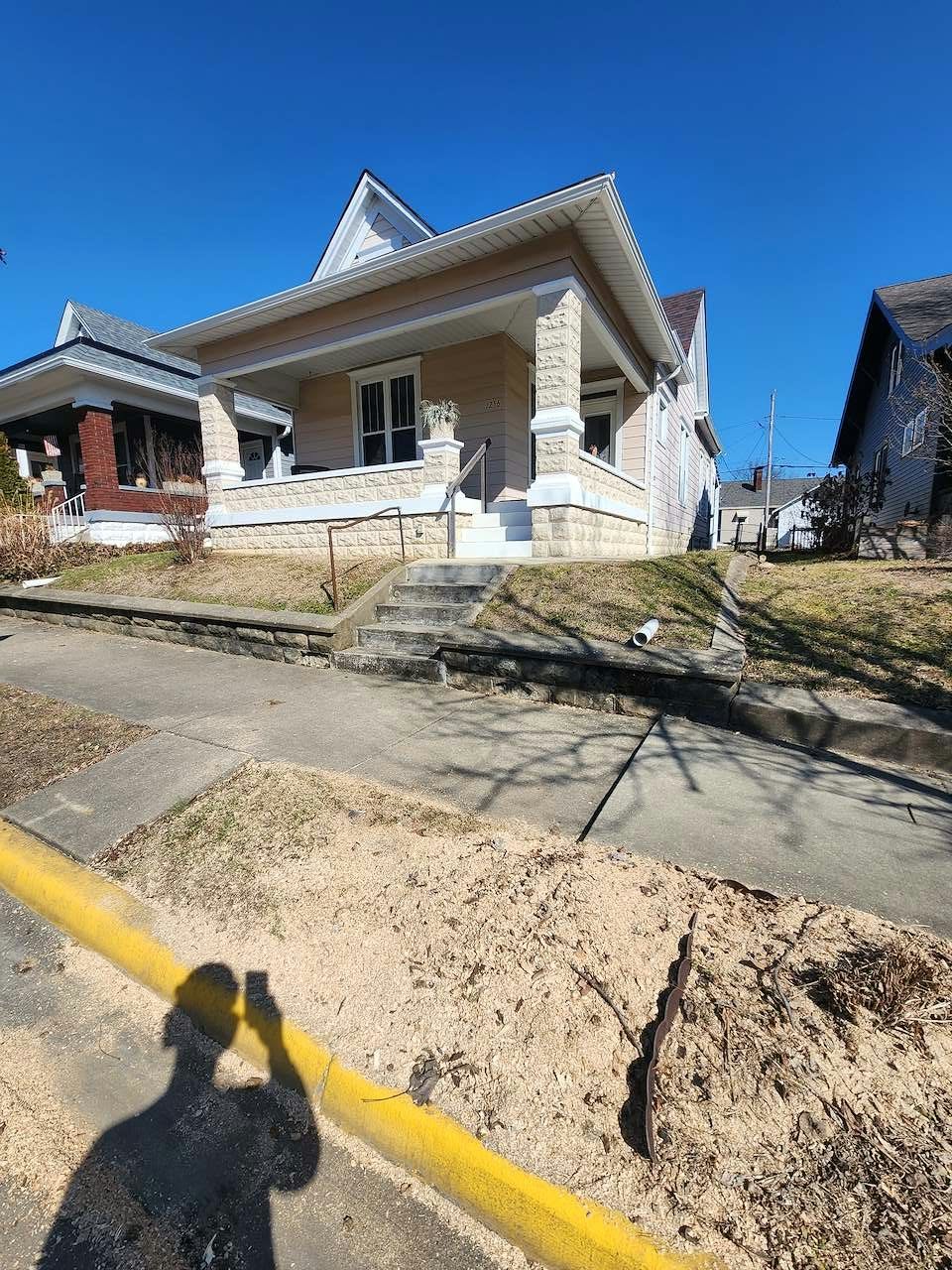 Fresh stump grindings cleared along a city sidewalk